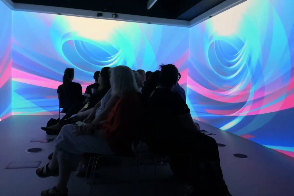 training group in room surrounded by immersive screens