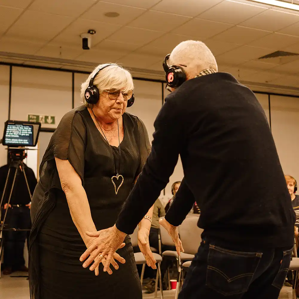 couple in community group practicing a performance