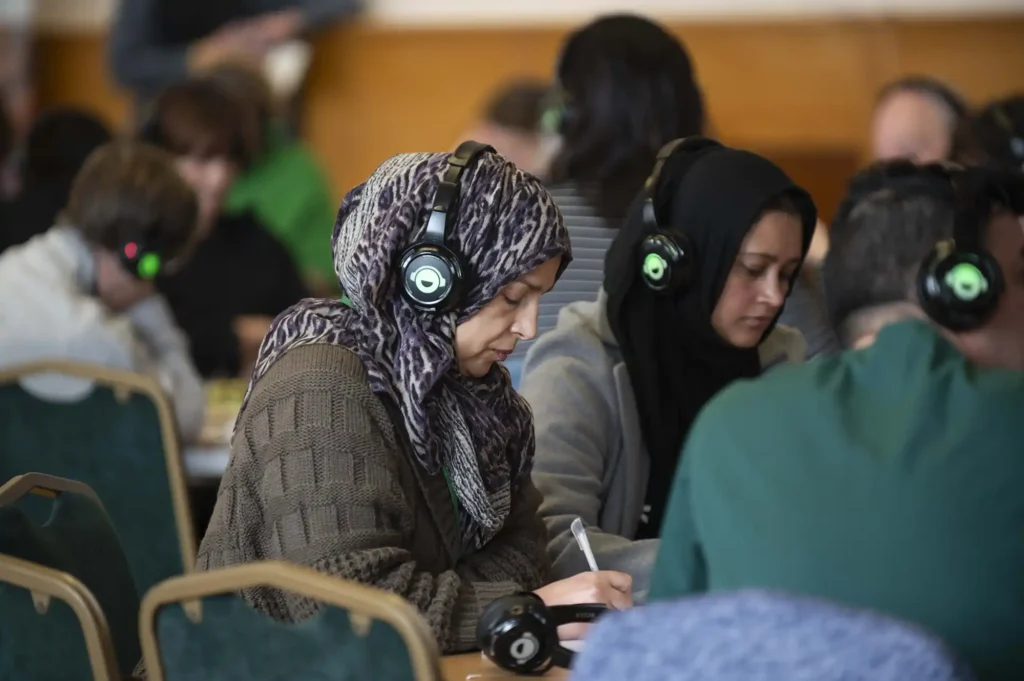 Group of researchers listening to audio stories and making notes